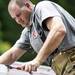 A firefighter works on a firetruck while responding to a house explosion near the intersection of Gattegno and Foley in Ypsilanti Township on Sunday, July 7. Daniel Brenner I AnnArbor.com